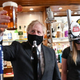 Boris Johnson holding a pint of ale at a British pub